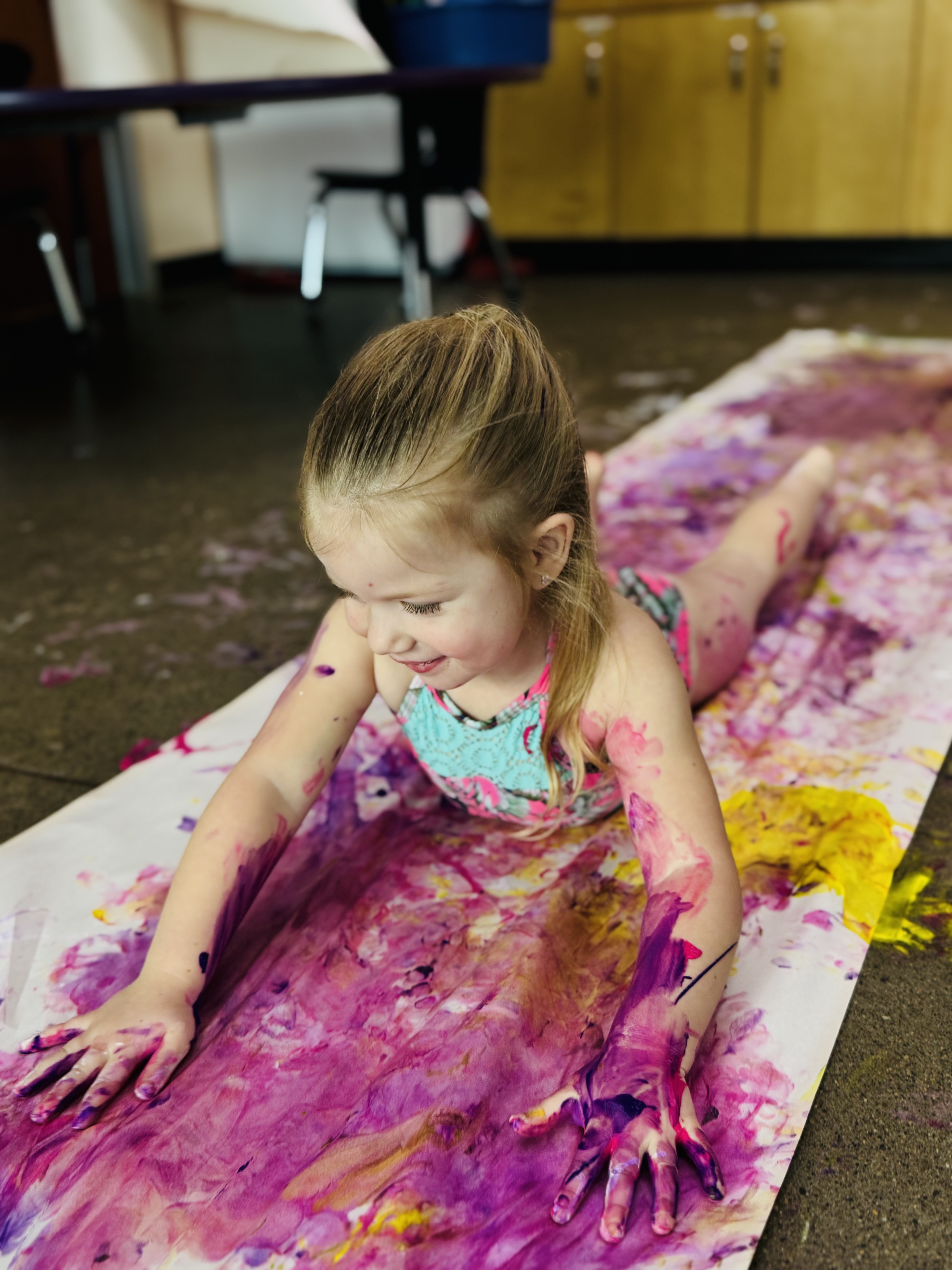 child painting with whole body