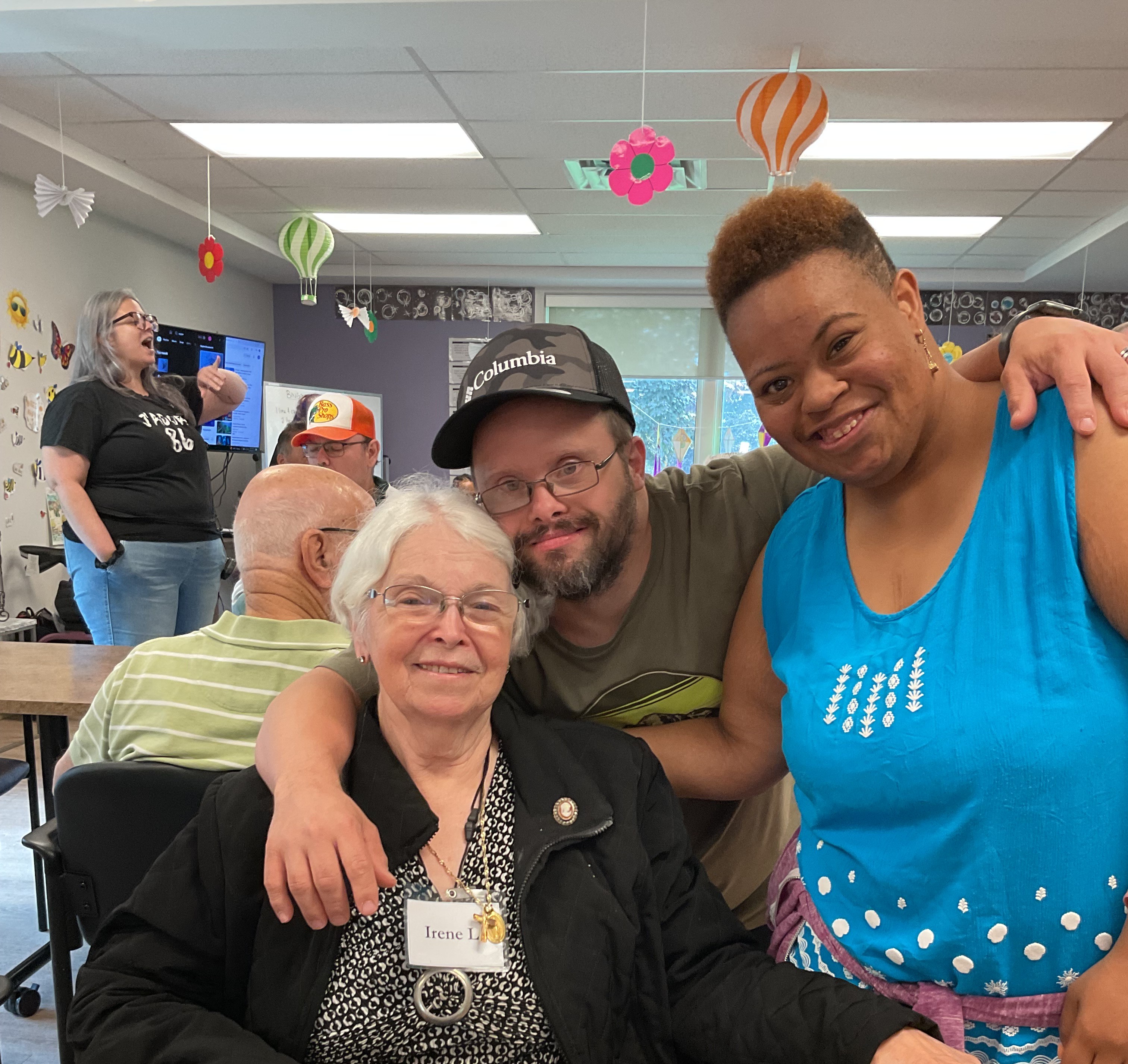 A group happily gathered during a seniors program.